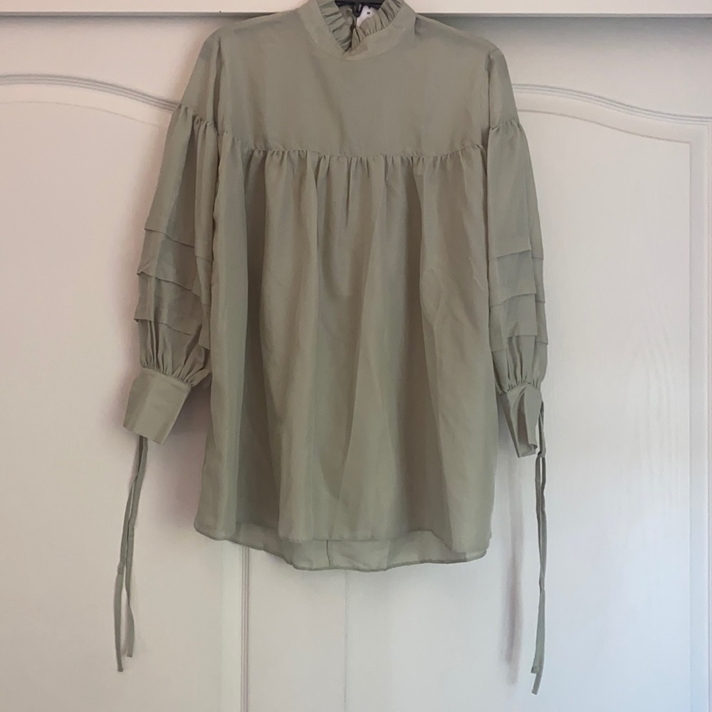 A sage green tunic